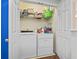 Laundry room with white washer and dryer, wire rack shelving, and bi-fold doors at 611 2Nd Ave. S # 18-C, North Myrtle Beach, SC 29582