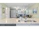 View of the living room from kitchen, with hardwood floors and a chandelier at 611 2Nd Ave. S # 18-C, North Myrtle Beach, SC 29582
