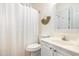 Bright bathroom featuring a shower/tub combo, toilet, single vanity, and minimalist decor at 611 N Ocean Blvd., Surfside Beach, SC 29575