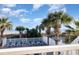 Beautiful beach access featuring lounge chairs and palm trees, perfect for relaxation and enjoying the ocean view at 611 N Ocean Blvd., Surfside Beach, SC 29575