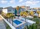 Community pool with lounge chairs, palm trees, and multiple homes at 611 N Ocean Blvd., Surfside Beach, SC 29575