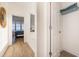 Hallway with a view of the bedroom and bathroom, featuring neutral walls and wood flooring at 611 N Ocean Blvd., Surfside Beach, SC 29575