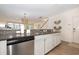 Bright kitchen with granite counters and stainless appliances, offering a view into the sunny living area at 611 N Ocean Blvd., Surfside Beach, SC 29575