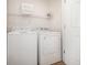 Efficient laundry room featuring a washer, dryer, and shelving for organized convenience at 611 N Ocean Blvd., Surfside Beach, SC 29575