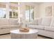 Comfortable living area with neutral-toned sofas and a round coffee table near the windows at 611 N Ocean Blvd., Surfside Beach, SC 29575