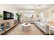 Bright living room with large windows, neutral furniture, and access to an outdoor balcony at 611 N Ocean Blvd., Surfside Beach, SC 29575