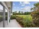 Back patio offers relaxing view of green golf course and lush landscaping on bright, sunny day at 612 Intracoastal Way Dr. # 103, Myrtle Beach, SC 29579