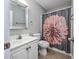 Bathroom with a single sink vanity, toilet, and shower/tub combo with floral shower curtain at 612 Intracoastal Way Dr. # 103, Myrtle Beach, SC 29579