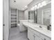 Bright bathroom features tile floor, a large mirror, a vanity, and built-in shelves at 612 Intracoastal Way Dr. # 103, Myrtle Beach, SC 29579