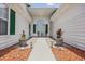 Inviting front porch with elegant decor, lush plants, and charming walkway at 612 Intracoastal Way Dr. # 103, Myrtle Beach, SC 29579