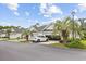 Attractive townhomes, green roof, manicured landscaping, and attached garages with modern white vehicle at 612 Intracoastal Way Dr. # 103, Myrtle Beach, SC 29579