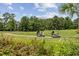 Picturesque golf course view of manicured green, marked path, and lush trees and foliage on sunny day at 612 Intracoastal Way Dr. # 103, Myrtle Beach, SC 29579