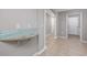 Hallway with granite counter and tiled floors lead to additional rooms within the home at 612 Intracoastal Way Dr. # 103, Myrtle Beach, SC 29579