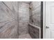 Modern shower with wood-look tiling and a new shower head at 612 Intracoastal Way Dr. # 103, Myrtle Beach, SC 29579