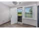 Bright sunroom featuring tiled floor, fan and natural light provided by a large window overlooking golf course at 612 Intracoastal Way Dr. # 103, Myrtle Beach, SC 29579