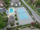 This is an aerial view of a tennis court, swimming pool, and surrounding vegetation at 614 14Th Ave. S # 47, Surfside Beach, SC 29575