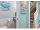 Charming powder room with coastal-themed artwork and beadboard paneling creates a refreshing atmosphere at 614 14Th Ave. S # 47, Surfside Beach, SC 29575