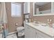 This bathroom features a white toilet, sink, and vanity with ample lighting and a window at 614 14Th Ave. S # 47, Surfside Beach, SC 29575