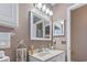 Well lit bathroom features neutral paint, dual mirrors and a vanity with a sink and cabinet at 614 14Th Ave. S # 47, Surfside Beach, SC 29575