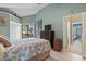 Bedroom with peaked ceilings featuring a TV, wooden dresser and access to a patio at 614 14Th Ave. S # 47, Surfside Beach, SC 29575