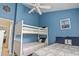 Stylish bedroom features a bunk bed, ceiling fan and beds with nautical themed decorations at 614 14Th Ave. S # 47, Surfside Beach, SC 29575