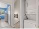 Hallway with laundry area leading to a bedroom with blue walls and a large window at 614 14Th Ave. S # 47, Surfside Beach, SC 29575