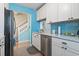 Modern kitchen featuring white cabinets, stainless steel appliances, and blue backsplash at 614 14Th Ave. S # 47, Surfside Beach, SC 29575