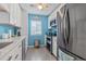 Efficient kitchen showcasing stainless steel appliances, white cabinets, and beautiful blue backsplash at 614 14Th Ave. S # 47, Surfside Beach, SC 29575