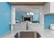Open-concept kitchen offering views into the living area, with bright blue walls and beachy decor at 614 14Th Ave. S # 47, Surfside Beach, SC 29575