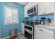 Bright kitchen features stainless steel appliances, blue backsplash, and charming beach-themed decor at 614 14Th Ave. S # 47, Surfside Beach, SC 29575