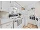 Well-lit kitchen with white appliances, white cabinets and adjacent dining area at 615 Carter Ln. # D6, Conway, SC 29526