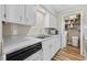 Bright kitchen features stainless steel sink, white cabinets, and modern appliances at 615 Carter Ln. # D6, Conway, SC 29526