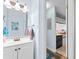 Bright bathroom featuring a modern vanity and a glimpse into the adjacent kitchen, ideal for guests at 620 15Th Ave. S # 87, Surfside Beach, SC 29575