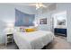 Airy bedroom flows into en-suite bath, decorated with a blue mandala tapestry and plush bedding at 620 15Th Ave. S # 87, Surfside Beach, SC 29575