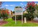 Ocean Pines community sign surrounded by lush landscaping and flowering trees, creating a welcoming entry at 620 15Th Ave. S # 87, Surfside Beach, SC 29575