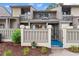 Townhome featuring private courtyard, stylish fence, well-maintained landscaping, and inviting entrance, creating an inviting first impression at 620 15Th Ave. S # 87, Surfside Beach, SC 29575