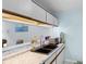 Kitchen with black double sink, white cabinets, solid countertop, and unique under cabinet lighting at 620 15Th Ave. S # 87, Surfside Beach, SC 29575