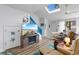 Bright and airy living room with vaulted ceilings, skylight, beach decor, and hardwood floors, enhancing a coastal ambiance at 620 15Th Ave. S # 87, Surfside Beach, SC 29575