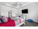 Bright bedroom with wood floors, white trim, a ceiling fan, and a large television at 628 Mccorkle Place, Conway, SC 29526