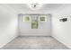 Bright room with three windows, gray carpet and mount for tv at 628 Mccorkle Place, Conway, SC 29526