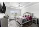 Main bedroom featuring a tray ceiling, ceiling fan, and a large window at 628 Mccorkle Place, Conway, SC 29526