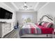 Main bedroom featuring a tray ceiling, ceiling fan, and a large window at 628 Mccorkle Place, Conway, SC 29526