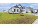 Beautifully landscaped front yard complements this home's white siding and inviting facade at 628 Mccorkle Place, Conway, SC 29526