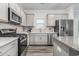 Modern kitchen with stainless steel appliances, granite countertops, and stylish cabinetry at 628 Mccorkle Place, Conway, SC 29526