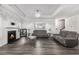 Elegant living area with fireplace, stylish decor, gray floors and coffered ceiling with chandelier at 628 Mccorkle Place, Conway, SC 29526
