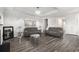 Open living area with wood-look flooring, tray ceiling, and neutral color scheme at 628 Mccorkle Place, Conway, SC 29526