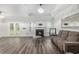 Spacious living room with fireplace, gleaming floors and natural light; great for entertaining at 628 Mccorkle Place, Conway, SC 29526