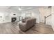 Bright living room features a fireplace, elegant lighting, and modern gray flooring at 628 Mccorkle Place, Conway, SC 29526