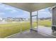 Inviting screened-in patio with views of a serene pond with a fountain at 628 Mccorkle Place, Conway, SC 29526