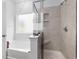 Close up of bright shower with showerhead, window, and built-in shelves at 628 Mccorkle Place, Conway, SC 29526